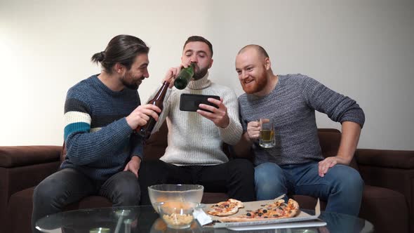 Three Cheerful Friends Male Greet Their Friends By Video Chat