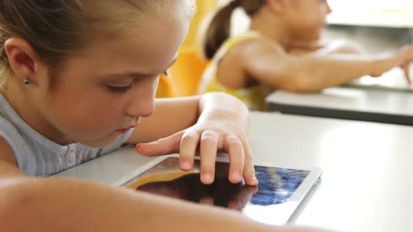 Girl using digital tablet in classroom