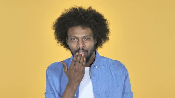 Flying Kiss By AfroAmerican Man on Yellow Background