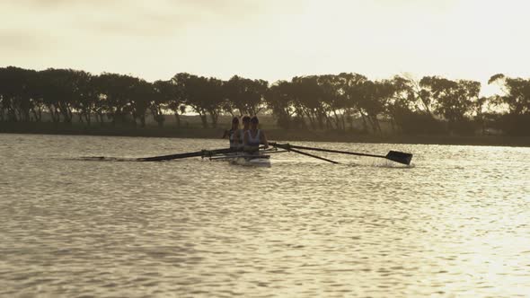 Female rowing team training on a river
