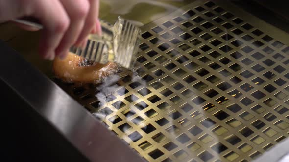 Donuts Frying in Boiling Oil