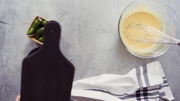 Step by step. Flat lay. Mixing ingredients together in glass mixing bowl for spicy jalapeno cornbrea