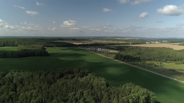 Small village among the fields of meadows and forests 07