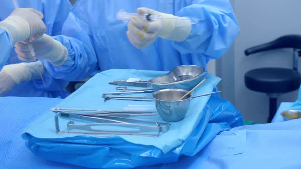 Scrub nurse preparing medical instruments for operation