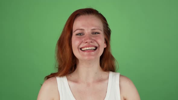 Happy Woman Smiling, Celebrating Success on Green Background