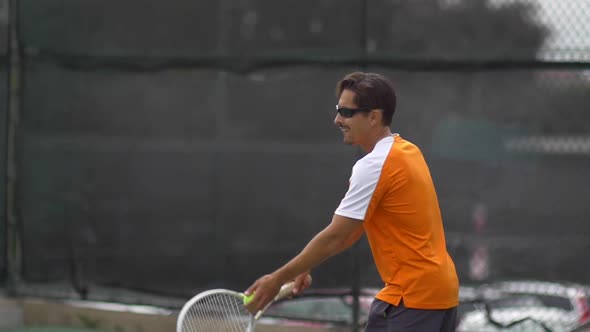 Tennis player practicing serve.