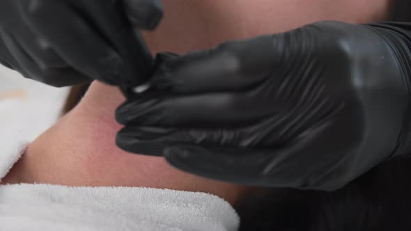 Young Woman Getting Electric Facials on Her Neck