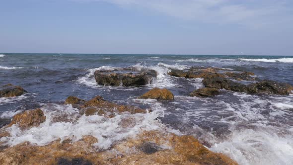 Sea Waves Break on the Coastal Rocks