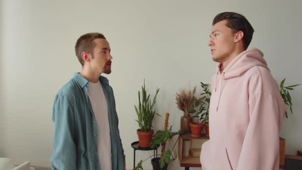 Standing in the Center of the Living Room Lgbt Men are Discussing and Sharing Their Opinions to Each