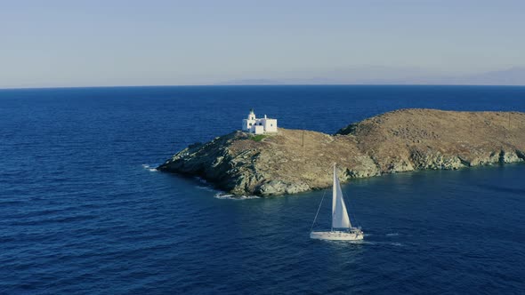 Sailing boat with white sails