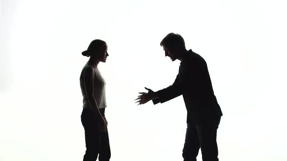 Silhouettes of Man and Woman Scream at Each Other and Swear