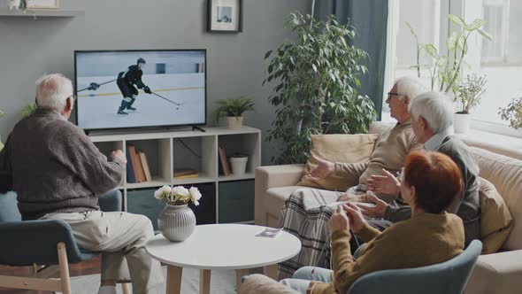 Seniors Watching Hockey Game on TV at Nursing Home