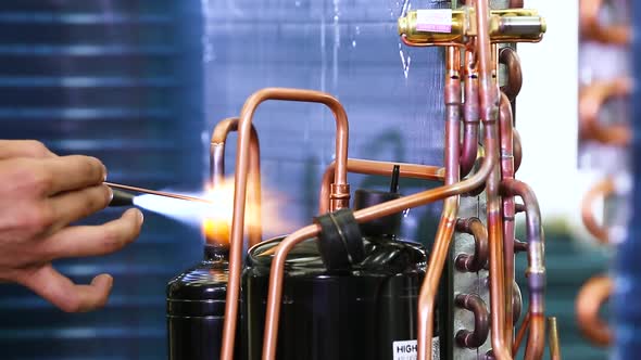 manual welding of copper pipes in the production of refrigerators