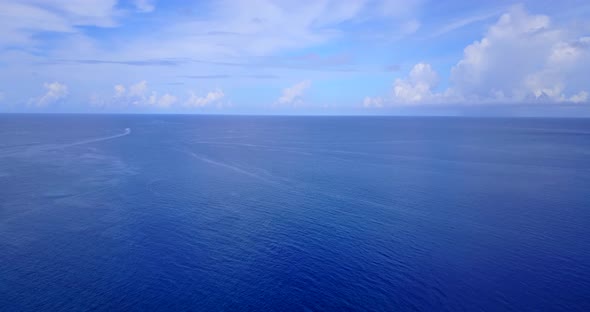 Beautiful flying copy space shot of a white sandy paradise beach and aqua blue water background in h