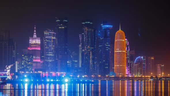 Traditional Dhow Boat in Doha at Night Timelapse with Modern Buildings in the