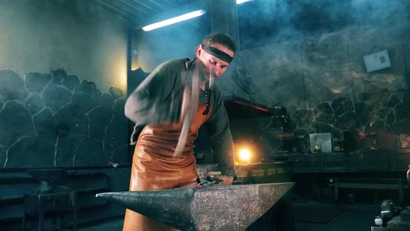 Hammering Process of a Metal Instrument Held By the Blacksmith