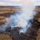 Aerial View of Waste Pile Burning with Red Fire on Grassland Field During Dry Season - VideoHive Item for Sale