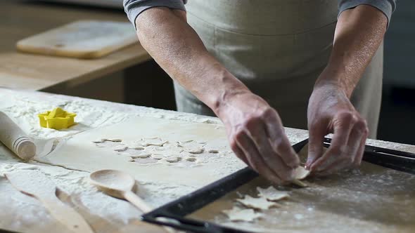 Grandmother Putting Out Star Shape Cookies on Baking Pan, Traditional Recipe