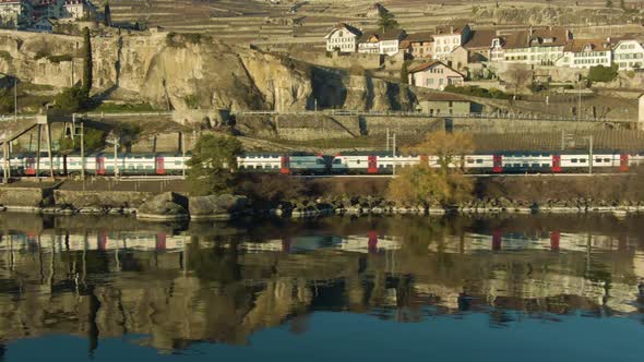 Double-Decker Train Goes Along Lake Geneva Shore. Switzerland. Aerial View