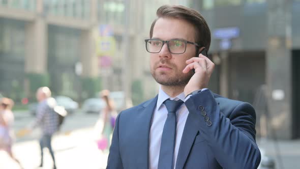 Businessman Talking Angrily on Smartphone