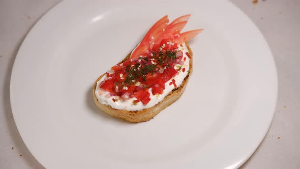 Avocado sandwiches, with tomatos and pepper, dill on a white background turning around