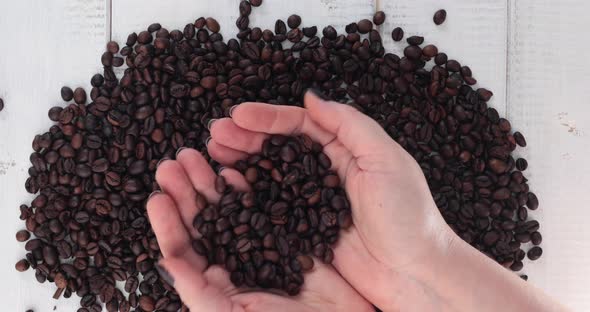 Woman hands holding coffee beans