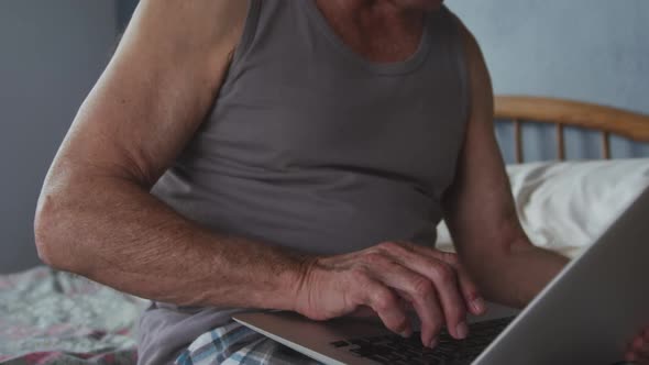 Senior man using laptop at home