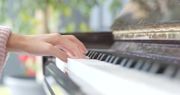 Woman hand playing piano