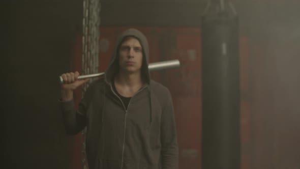 Grim Looking Hoodlum in Hoodie Holding Baseball Bat