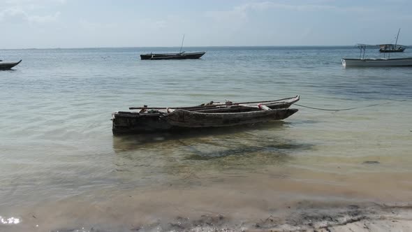 Old Dry African Fishing Rowboat Anchored on Beach at Low Tide Zanzibar