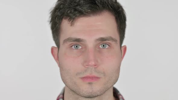 Close Up of Serious Young Man Looking at Camera