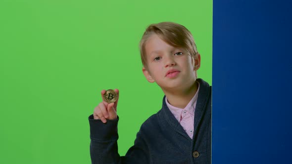 Teenager Comes Out From Behind the Wall Shows the Coin and the Trumb Up on a Green Screen