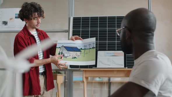 Engineer Presenting Renewable Energy Home Project to Coworkers