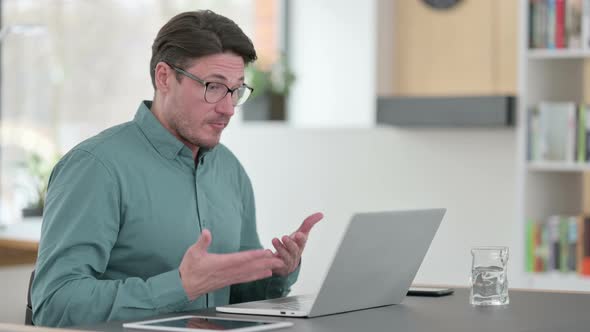 Middle Aged Man Speaking on Video Call on Laptop