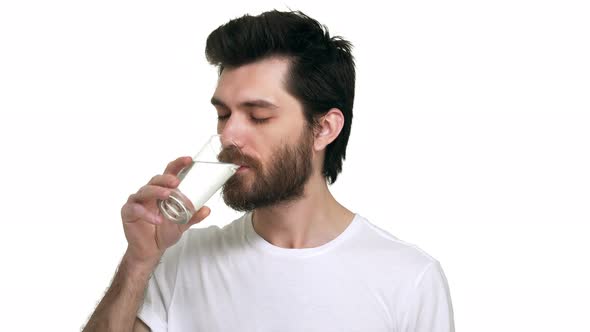 Caucasian Male Holding a Glass of Water Drinking Smiling Satisfied on White Background