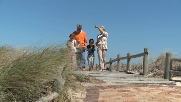 LS OF GRANDPARENTS AND THEIR GRANDCHILDREN WALKING ALONG A PATH