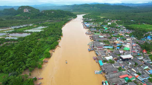 Aerial shot of river and local fisherman village beside the sea