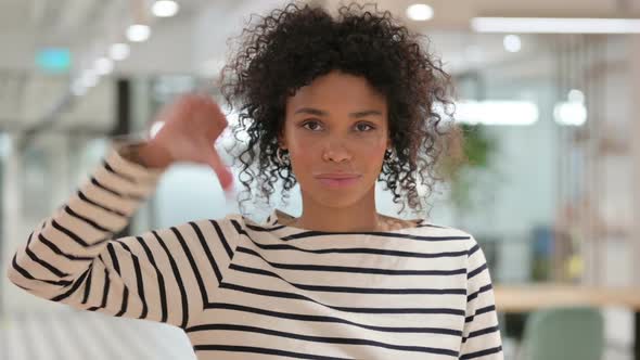 Disappointed African Woman Doing Thumbs Down