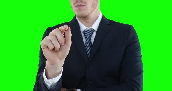 Mid section of a Caucasian man raising hand on green background