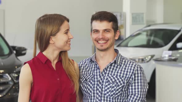 Happy Couple Posing with Car Keys To Their New Auto