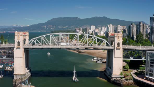 Sailboat Sailing At False Creek Under Burrard Bridge - English Bay And Downtown Vancouver In Canada.