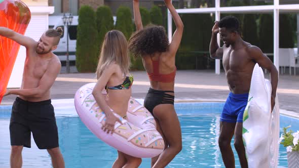 Joyful Diverse Friends Having Fun Dancing By Pool