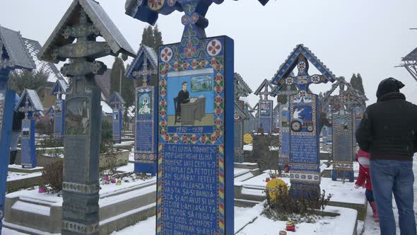 Man visiting the Merry Cemetery during winter 