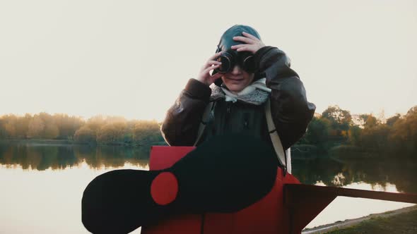 Beautiful Portrait of Happy Little Girl Putting Glasses on in Fun Plane Pilot Costume Looking at