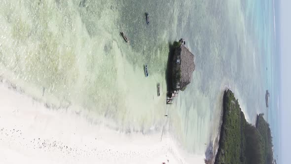 Vertical Video House on Stilts in the Ocean on the Coast of Zanzibar Tanzania Aerial View