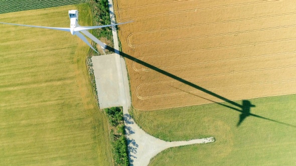 Windmill for electric power production in the agricultural fields. View from above.