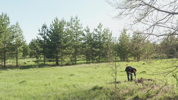 A Man Is Looking for Metal with a Metal Detector