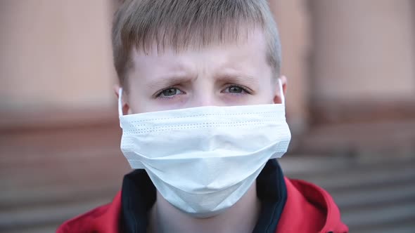 Portrait of Little Boy Wearing Medical Mask on Street in City