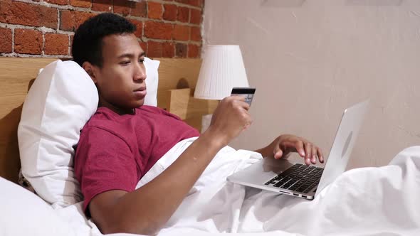 Online Payment Failure Upset African Man in Bed Trying to Shop Online