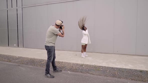 A Photographer and a Model Doing a Fashion Shoot on the Street